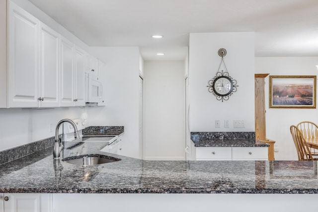 13 Laurel Hill Ct, Bourne, MA 02532 - kitchen featuring a sink, white microwave, dark stone countertops, white cabinetry, and recessed lighting