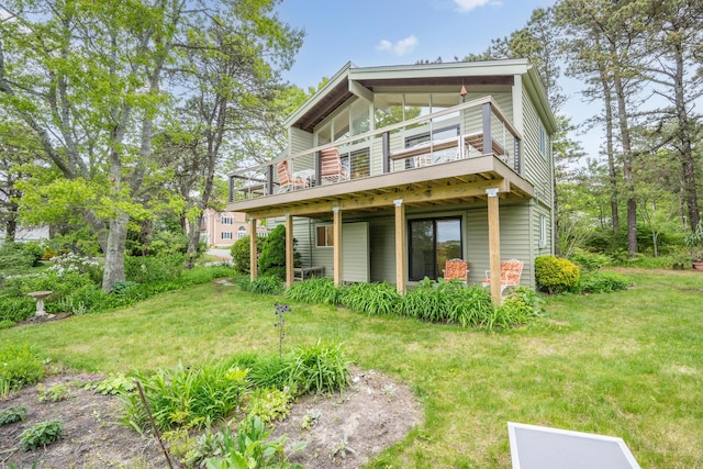 128 Whippoorwill Cir, Mashpee, MA 02649 - rear view of house featuring a yard and a wooden deck