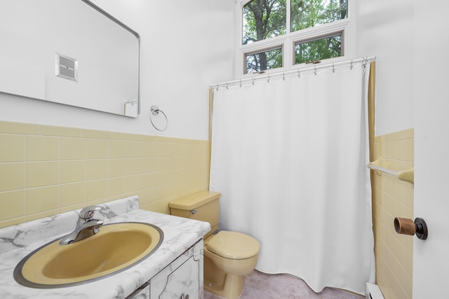 128 Whippoorwill Cir, Mashpee, MA 02649 - bathroom featuring tile walls, vanity, toilet, curtained shower, and a baseboard heating unit