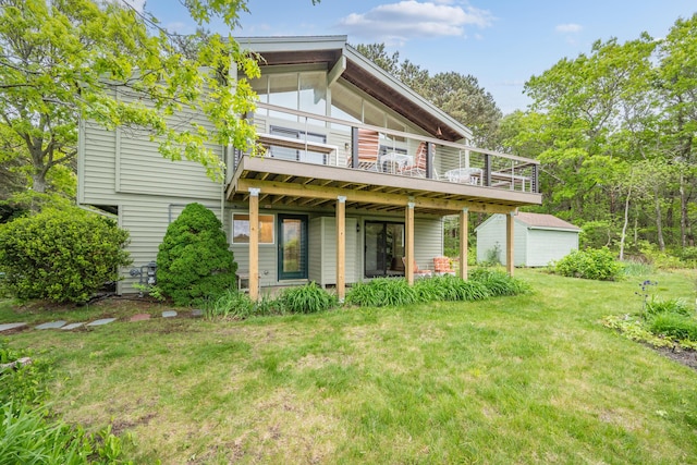 128 Whippoorwill Cir, Mashpee, MA 02649 - rear view of property with a lawn, an outbuilding, and a deck