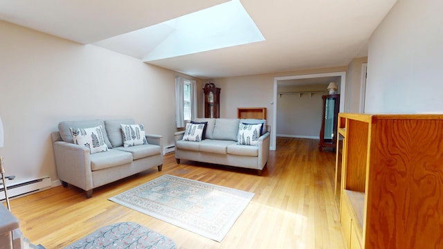 10 Freeman Rd, Yarmouth Port, MA 02675 - living area featuring a baseboard radiator, light wood-style flooring, and a skylight