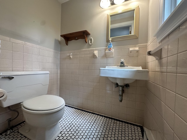 10 Freeman Rd, Yarmouth Port, MA 02675 - half bathroom featuring tile walls, tile patterned floors, and a wainscoted wall