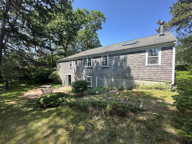 10 Freeman Rd, Yarmouth Port, MA 02675 - rear view of house featuring a shingled roof and a yard