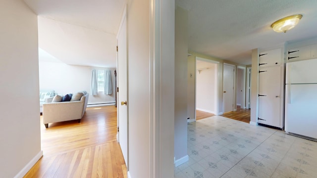 10 Freeman Rd, Yarmouth Port, MA 02675 - corridor with baseboard heating and light wood-type flooring