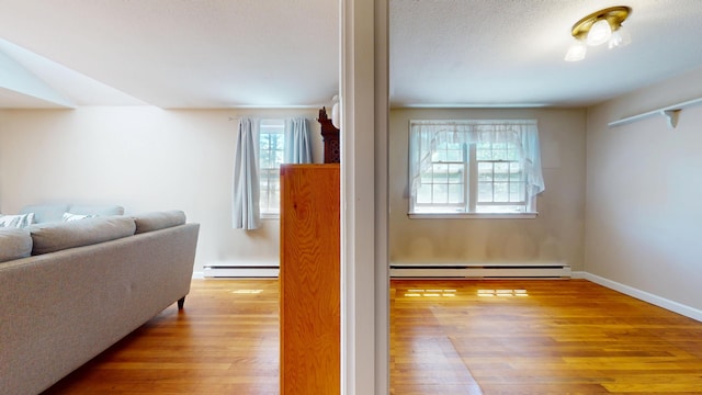 10 Freeman Rd, Yarmouth Port, MA 02675 - living area featuring wood finished floors and a baseboard radiator
