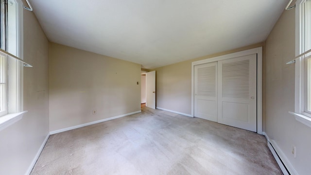 10 Freeman Rd, Yarmouth Port, MA 02675 - unfurnished bedroom featuring a baseboard heating unit, a closet, and carpet floors