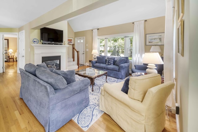 4 Square Rigger Ln, Hyannis, MA 02601 - living area with light wood-type flooring, a glass covered fireplace, and lofted ceiling