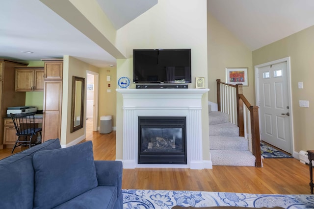 4 Square Rigger Ln, Hyannis, MA 02601 - living room featuring light wood-style floors, stairs, high vaulted ceiling, and a glass covered fireplace