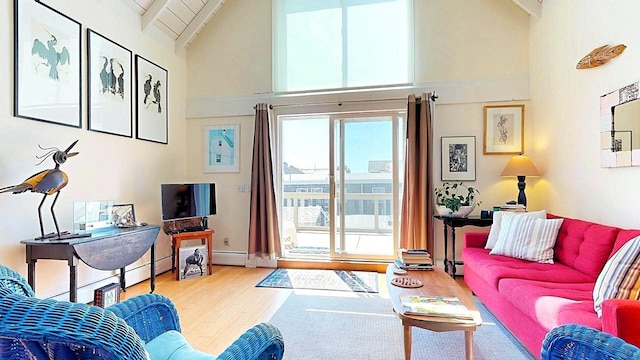 living room with hardwood / wood-style flooring, high vaulted ceiling, beam ceiling, and wood ceiling