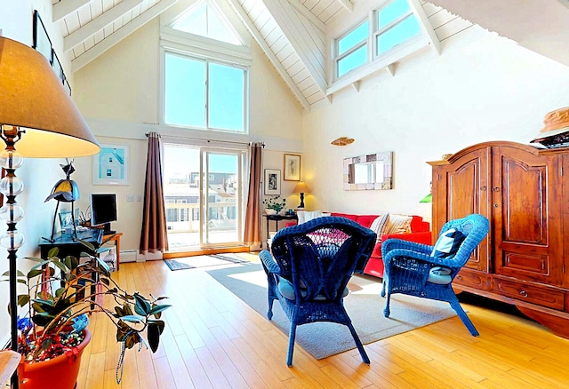 living room with high vaulted ceiling, wooden ceiling, beamed ceiling, and light wood-type flooring