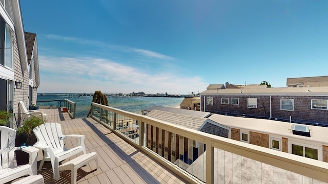 wooden terrace featuring a water view