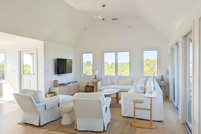 living room featuring light hardwood / wood-style floors and lofted ceiling