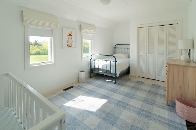 bedroom featuring a closet and lofted ceiling