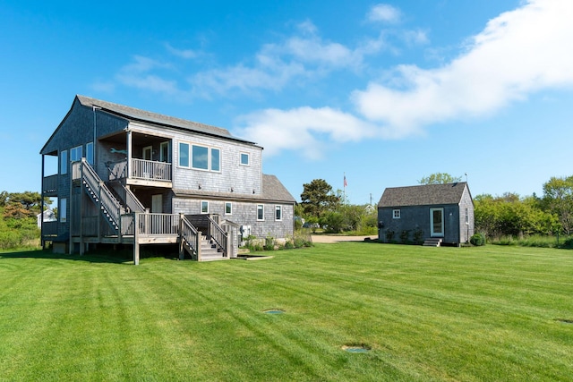 rear view of house with a deck and a lawn