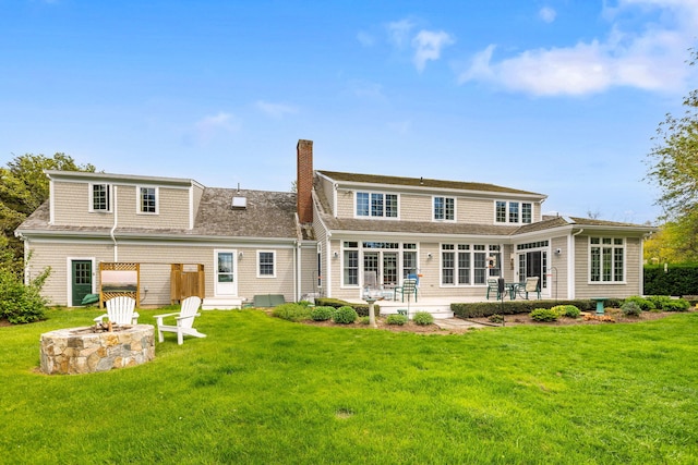 46 Freeman Ln, Orleans, MA 02653 - back of property featuring a fire pit, a chimney, a patio, and a lawn