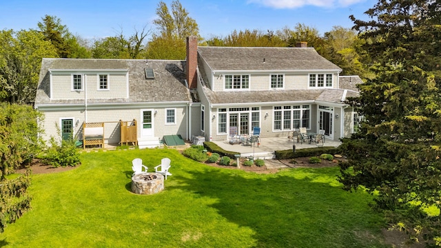 46 Freeman Ln, Orleans, MA 02653 - rear view of property with a fire pit, a yard, a patio, and a chimney