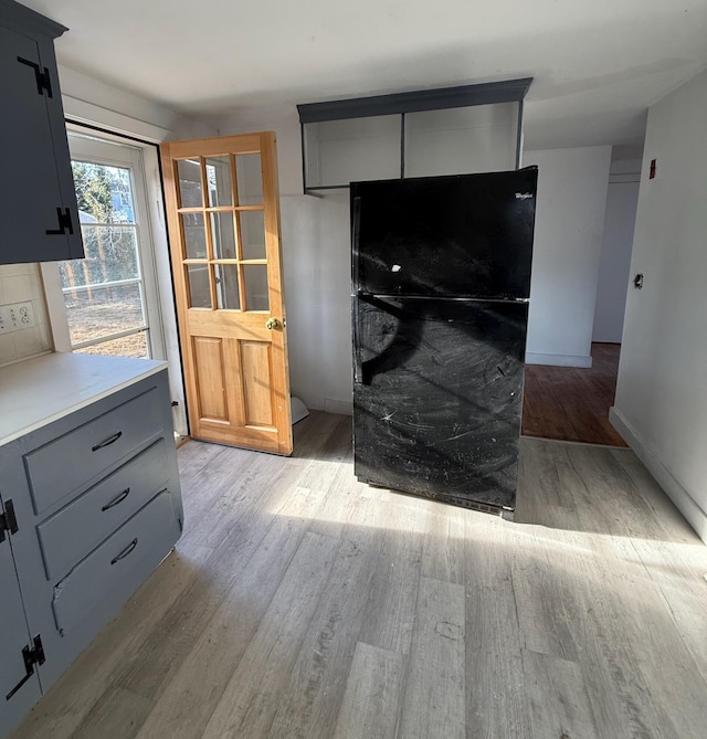 interior space featuring baseboards and wood finished floors