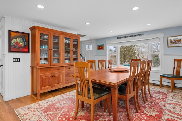 dining area with baseboard heating and light wood-type flooring