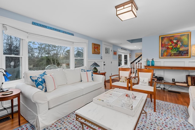 living room featuring light wood-type flooring and a baseboard heating unit