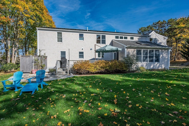 rear view of property with a yard