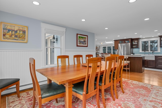 dining space with sink and light hardwood / wood-style flooring