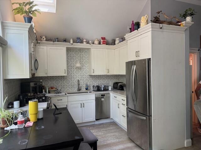 155 Mitchells Way, Barnstable, MA 02601 - kitchen with stainless steel appliances, white cabinets, and decorative backsplash