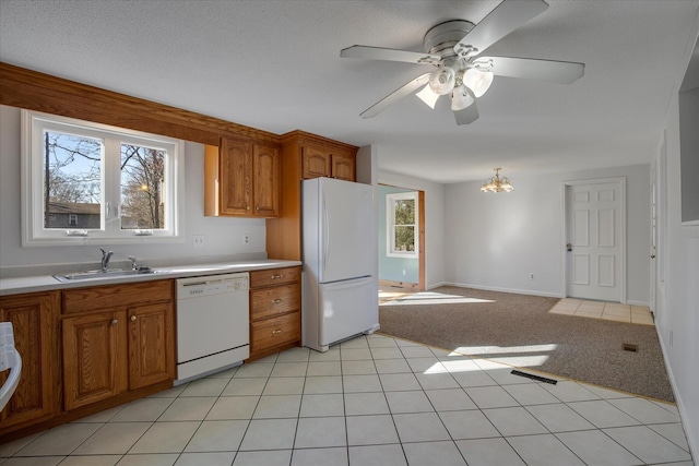 4 Inkberry Cir, Sandwich, MA 02563 - kitchen featuring ceiling fan with notable chandelier, white appliances, light countertops, a sink, and brown cabinets