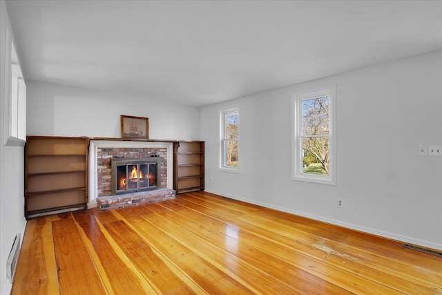 4 Inkberry Cir, Sandwich, MA 02563 - unfurnished living room featuring a fireplace, visible vents, baseboards, and hardwood / wood-style floors