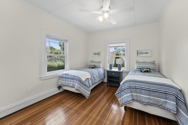 bedroom featuring ceiling fan, baseboard heating, and dark wood-type flooring