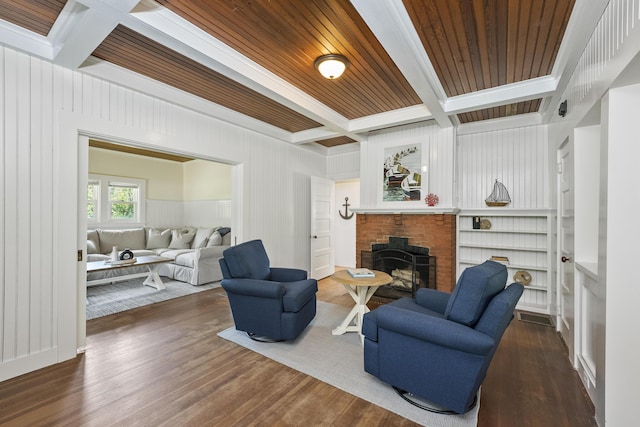 living room with beamed ceiling, a fireplace, wood ceiling, coffered ceiling, and dark hardwood / wood-style floors