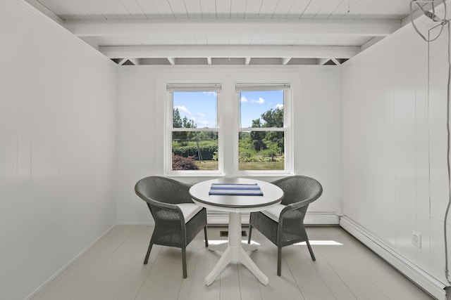 dining space with beamed ceiling and a baseboard radiator