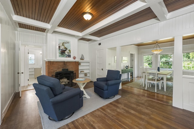 living room featuring dark hardwood / wood-style flooring, built in features, wooden ceiling, coffered ceiling, and beamed ceiling