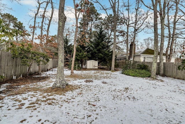 snowy yard with a storage unit