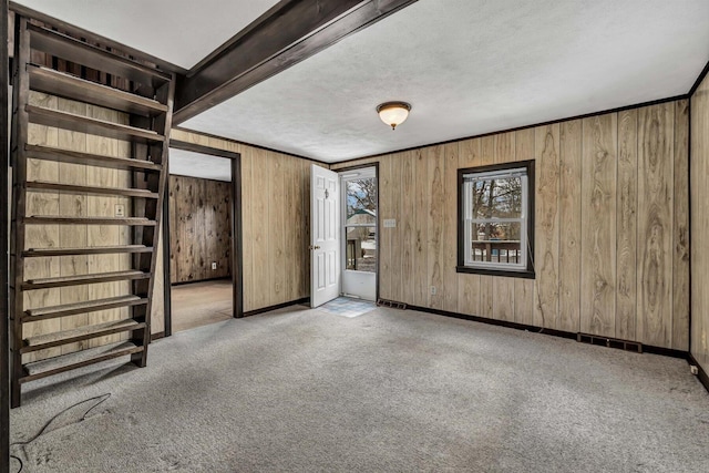 empty room with light carpet and a textured ceiling