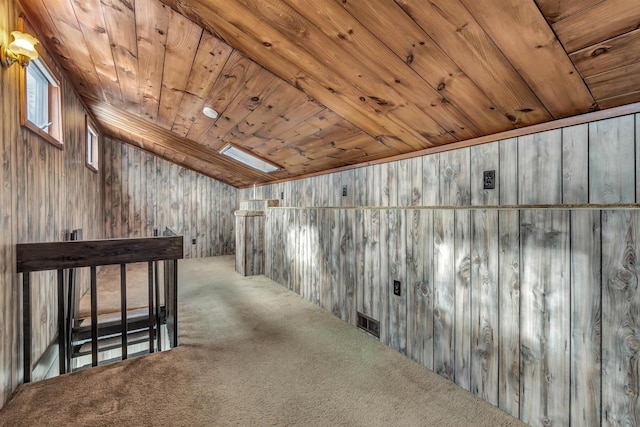 interior space with wood ceiling, wooden walls, and carpet flooring