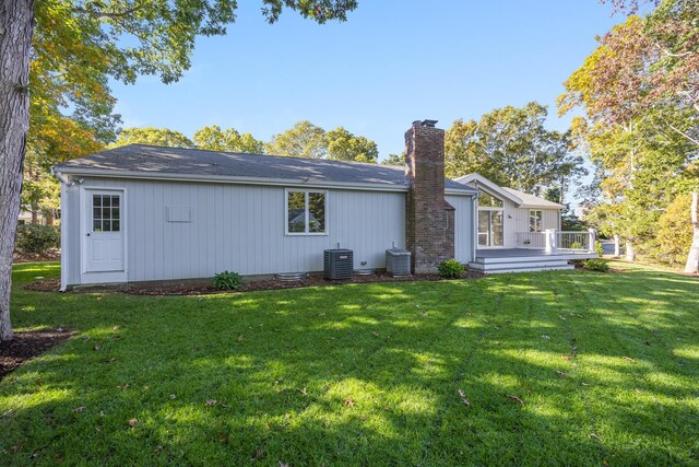 back of house with a wooden deck, cooling unit, and a yard