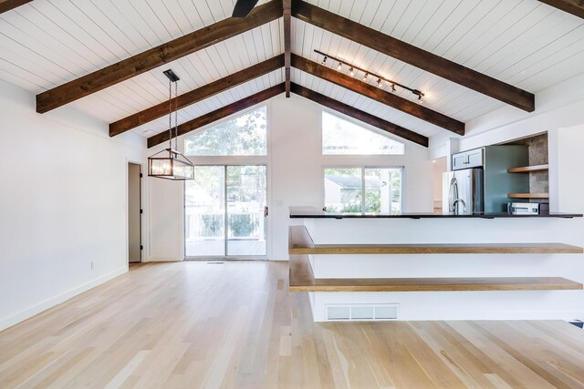 unfurnished living room featuring wooden ceiling, light hardwood / wood-style flooring, beam ceiling, and high vaulted ceiling