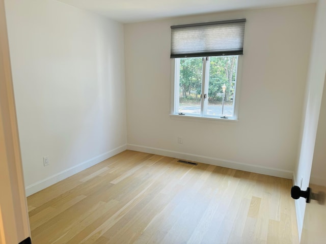 spare room with light hardwood / wood-style floors