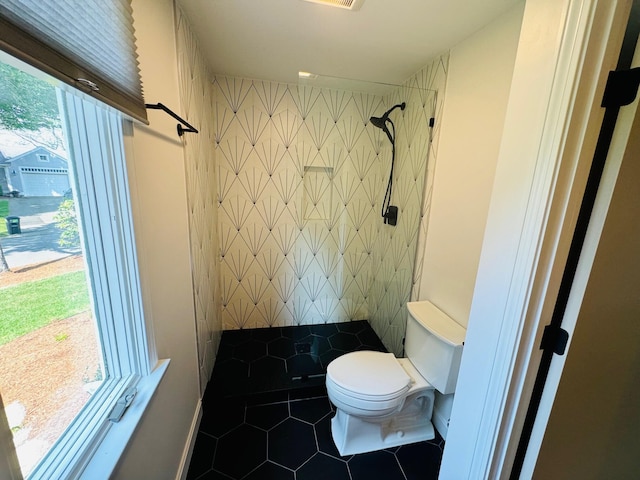 bathroom featuring toilet, walk in shower, and tile patterned floors