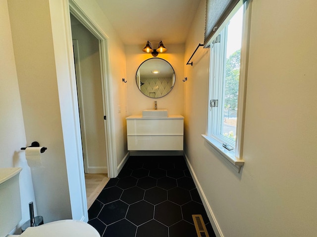 bathroom with vanity, plenty of natural light, and tile patterned flooring