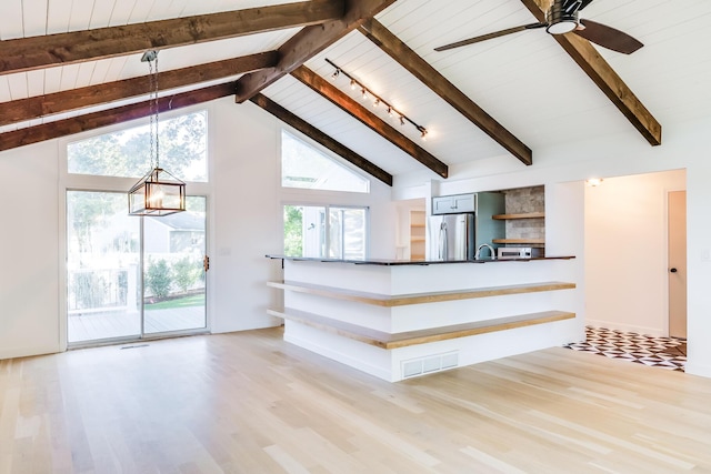 unfurnished living room featuring high vaulted ceiling, track lighting, beam ceiling, and light wood-type flooring