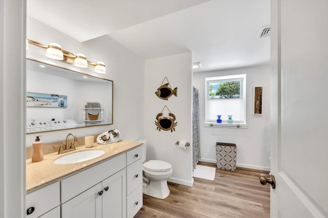 39 Nehoiden Rd, Mashpee, MA 02649 - bathroom featuring vanity, toilet, wood finished floors, and a shower with shower curtain