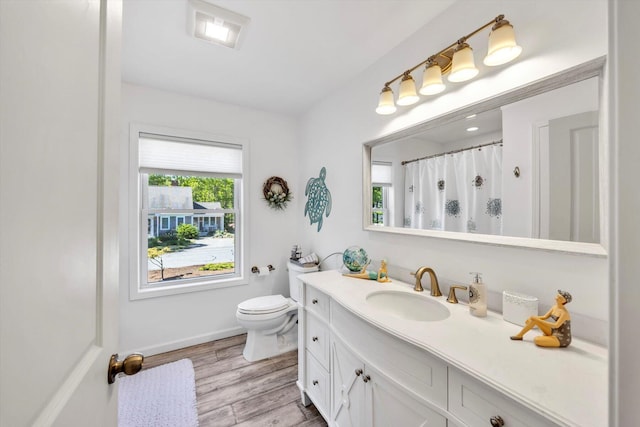 39 Nehoiden Rd, Mashpee, MA 02649 - full bathroom with toilet, vanity, wood finished floors, baseboards, and a shower with curtain