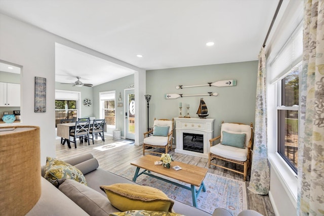 39 Nehoiden Rd, Mashpee, MA 02649 - living room with light wood finished floors, recessed lighting, a glass covered fireplace, a ceiling fan, and baseboards