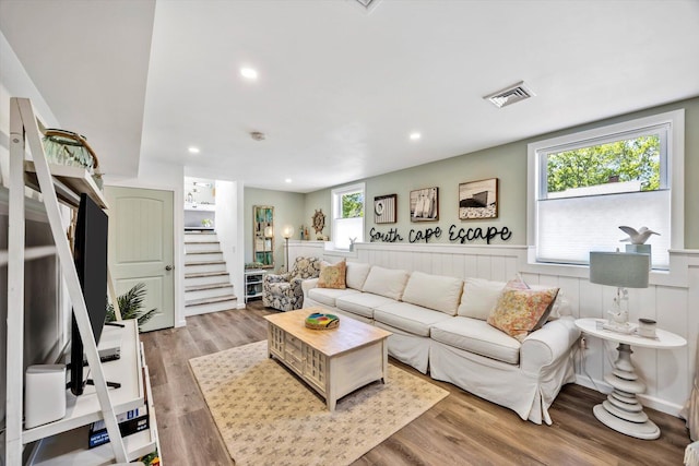 39 Nehoiden Rd, Mashpee, MA 02649 - living room with stairs, wood finished floors, recessed lighting, and a wainscoted wall