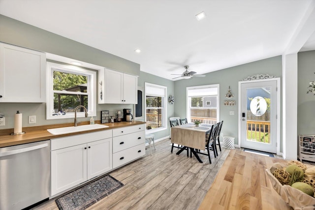 39 Nehoiden Rd, Mashpee, MA 02649 - kitchen featuring stainless steel dishwasher, wood counters, a sink, white cabinets, and light wood-type flooring
