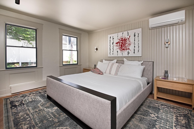 3 Carver Ct, Provincetown, MA 02657 - bedroom with a wall mounted air conditioner, a decorative wall, and wood finished floors