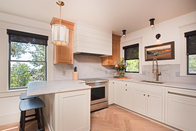 3 Carver Ct, Provincetown, MA 02657 - kitchen featuring stainless steel range with electric cooktop, a peninsula, premium range hood, and tasteful backsplash