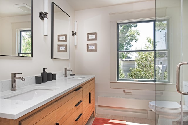 3 Carver Ct, Provincetown, MA 02657 - bathroom featuring double vanity, plenty of natural light, and a shower with door