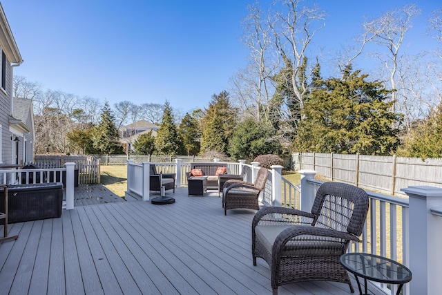 deck with an outdoor hangout area and a fenced backyard